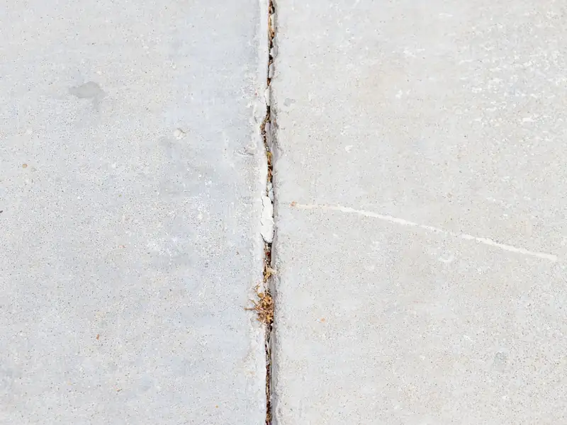 Concrete panel joint that has opened up with a chipped, spalled edge
