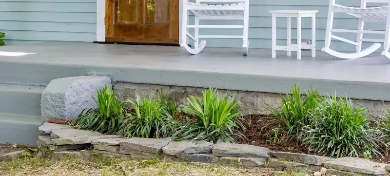 Coated concrete porch slab and two front steps, the kind of sound surface an overlay can refresh